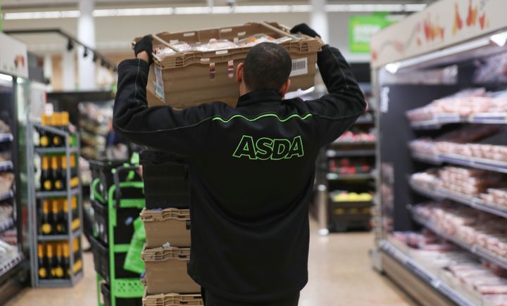 An employee stocks shelves at the Asda superstore in High Wycombe, Britain, February 8, 2017. REUTERS/Eddie Keogh