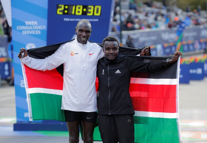 Kenya's Geoffrey Kamworor and Kenya's Joyciline Jepkosgei pose as they celebrate winning the men's and women's elite races respectively on Sunday.