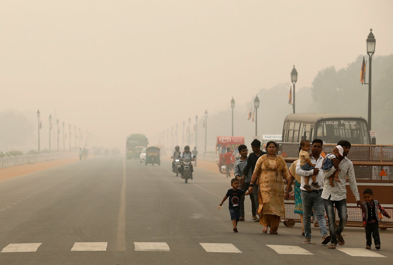 <strong>People walk on the Rajpath on a smoggy day in November</strong>
