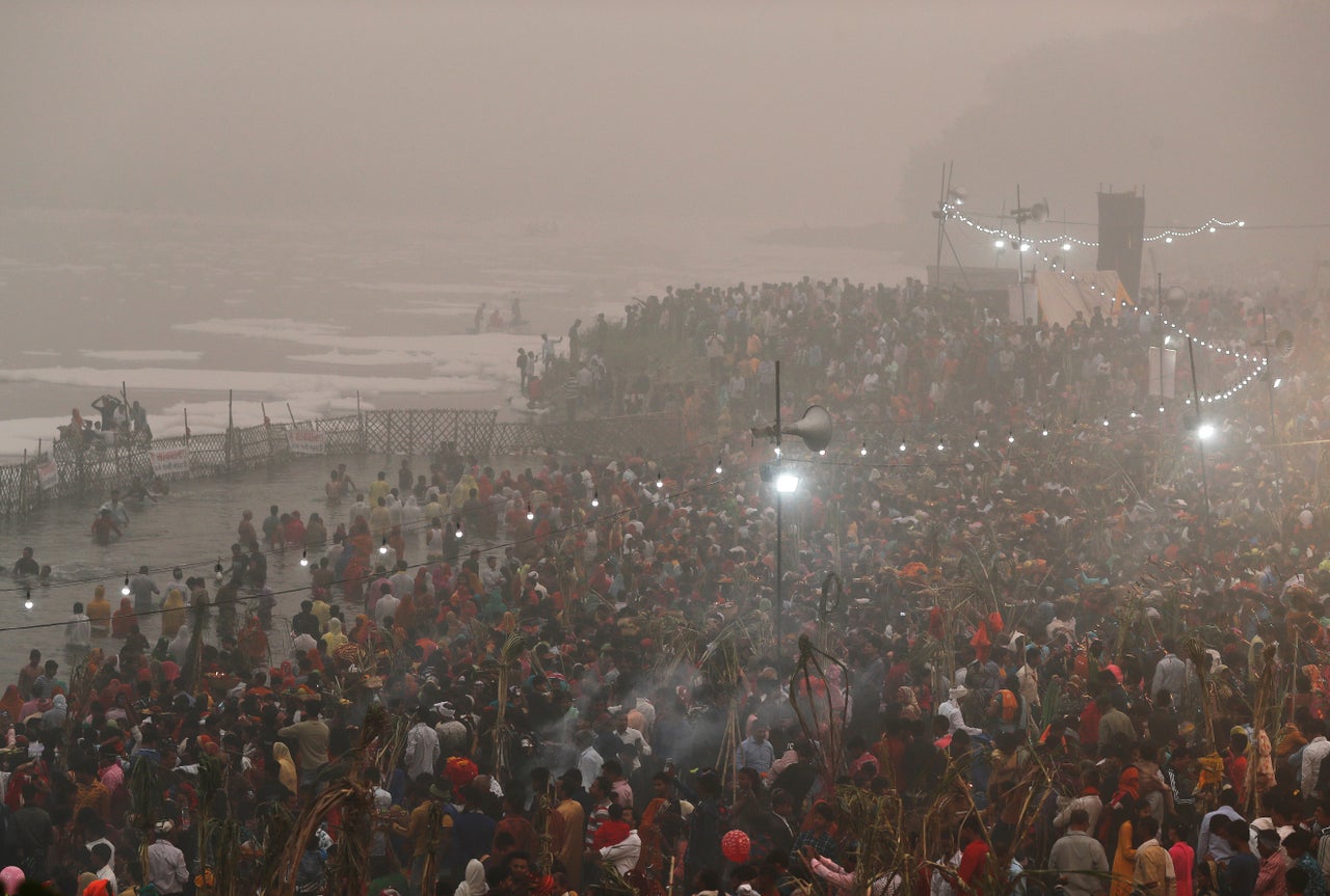 Hindu devotees worship the Sun god in the polluted waters of the river Yamuna during the Hindu religious festival of Chatth Puja