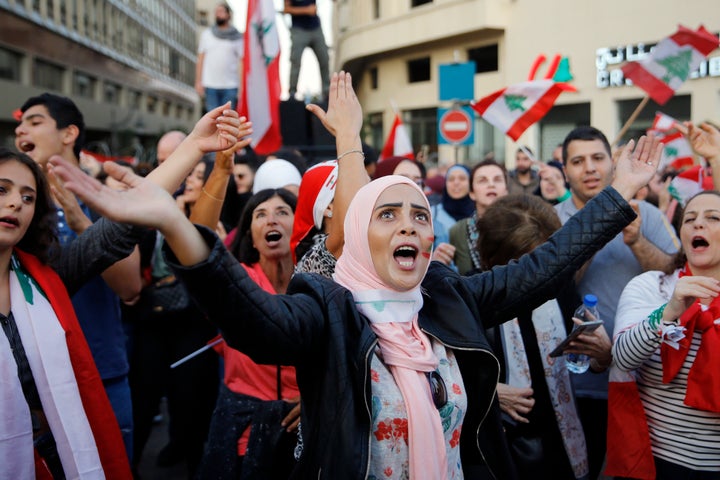 Anti-government protesters chant slogans against the Lebanese government, in Beirut, Lebanon, Sunday, Nov. 3, 2019.