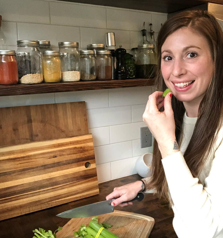 Adriana Dikih, who blogs about vegan food and recipes, poses in her kitchen.