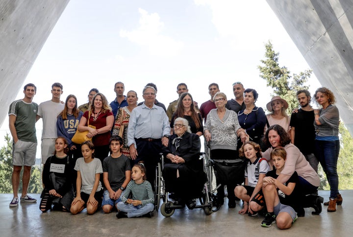 Dina poses for a group photo with the descendants of the Mordechai family, whom she helped save during the Holocaust.