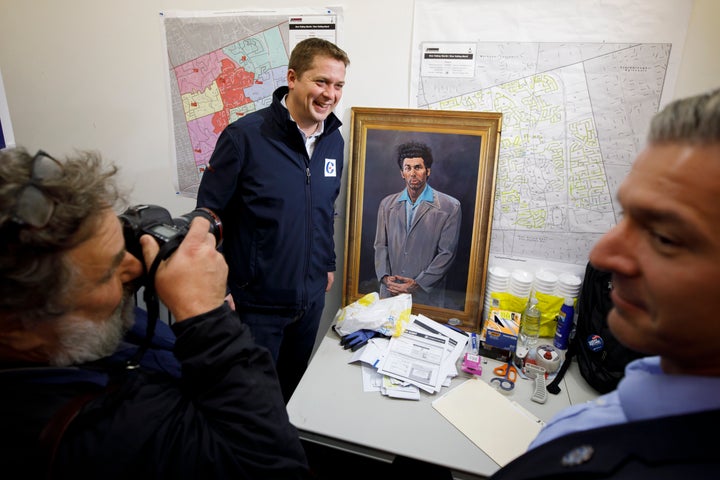 Andrew Scheer poses beside a portrait of "Seinfeld" character Kramer during a campaign stop on Oct. 19, 2019 in North York, Ont.