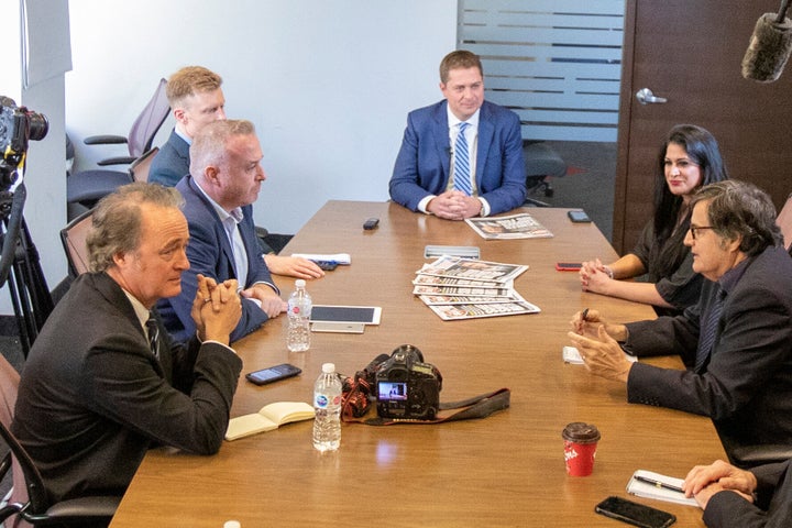 Warren Kinsella, front left, and the editorial board of the Toronto Sun meet with Conservative Leader Andrew Scheer, centre, in Toronto on Oct. 8, 2019.