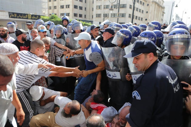 ALGIERS, ALGERIA - OCTOBER 13: Security officers intervene in protesters as Algerians stage a protest...