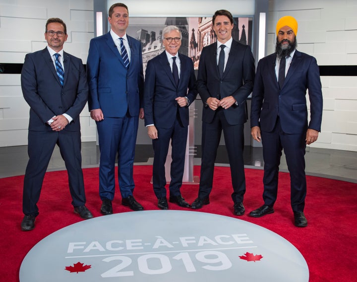 From left to right: Bloc Quebecois Leader Yves-François Blanchet, Conservative Leader Andrew Scheer, TVA network host Pierre Bruneau, Liberal Leader Justin Trudeau and NDP Leader Jagmeet Singh pose before the TVA debate in Montreal on Oct. 2, 2019.
