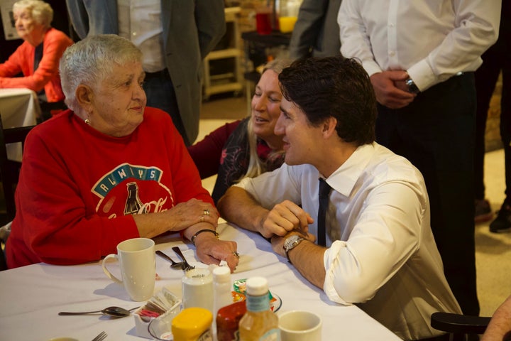 Justin Trudeau chats with Pat Millington, who wore red for the occasion. The Liberal leader was visiting the Emerald Retirement Residence in Niagara Falls, Ont.