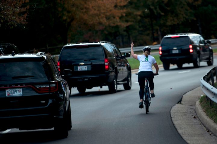 Juli Briskman shows her middle finger as a motorcade with President Donald Trump departs Trump National Golf Course in Sterling, Virginia, in 2017. Two years later, Briskman is on the ballot for local office.