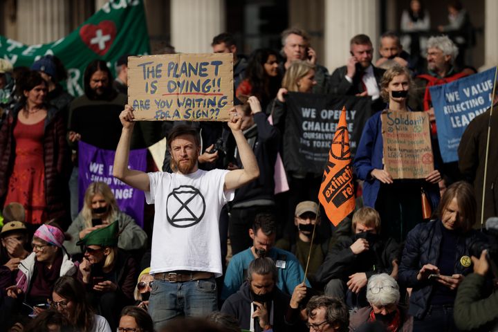 Extinction Rebellion climate change protesters hold placards calling for action on climate change during a rally in Trafalgar Square, London in October 
