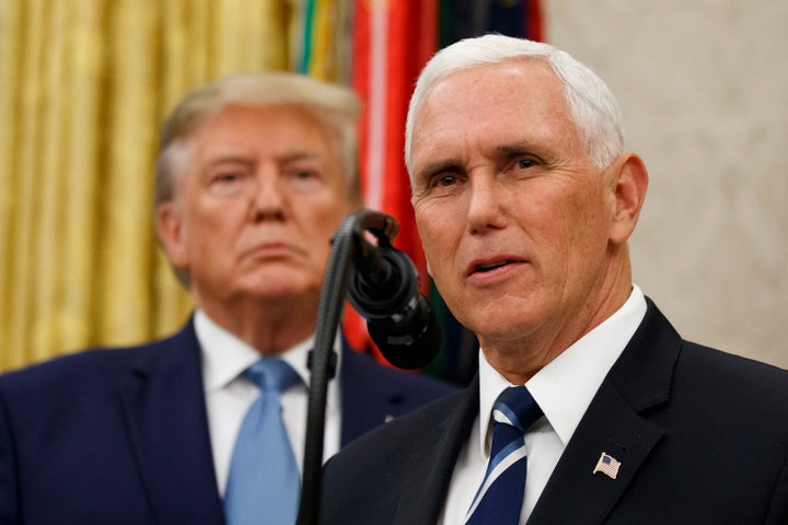 Vice President Mike Pence, right, speaks with President Donald Trump behind him, during a ceremony to present the Presidential Medal of Freedom to former Attorney General Edwin Meese on Oct. 8.