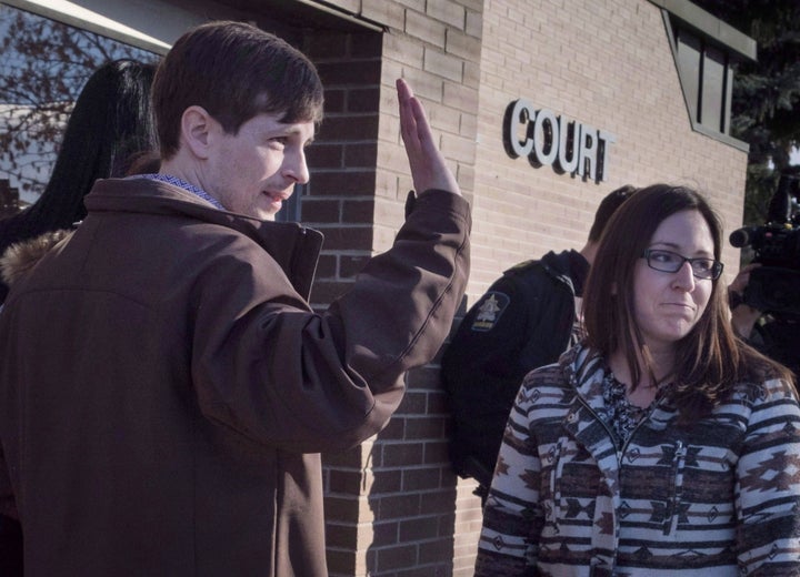 Edouard Maurice waves to supporters outside court with his wife Jessica in Okotoks, Alta. on Mar. 9, 2018. 