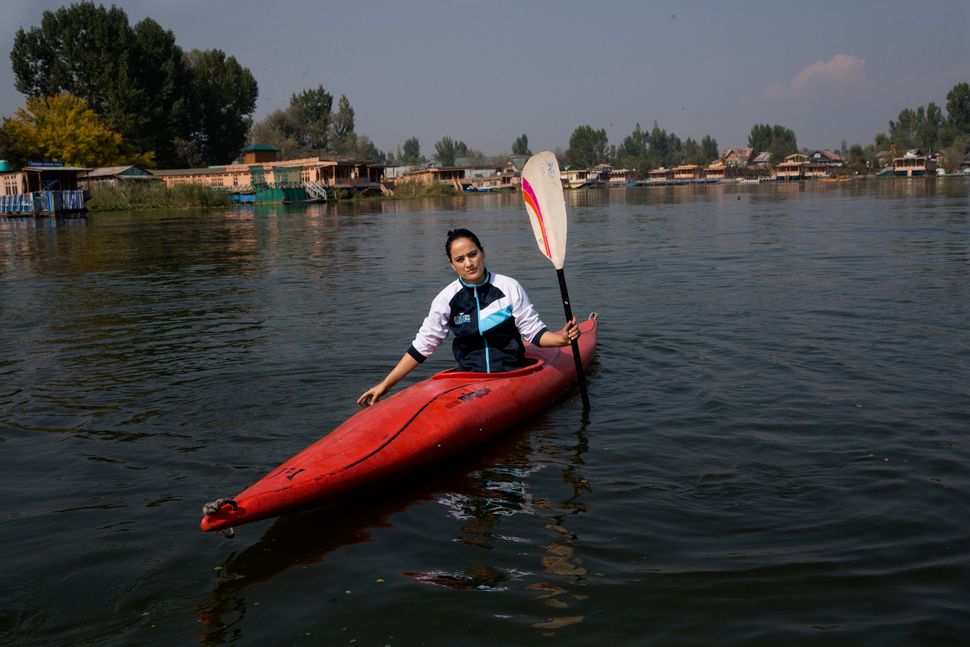 In this Friday, Oct. 25, 2019, photo, a Kashmiri kayaker Mehak Peer, 26, sits for a photograph during her first practice session since Aug. 5, on the Dal Lake in Srinagar. “Because of the lockdown and internet blockade we have missed three tournaments. I was hoping to make it to the international level but after missing these national tournaments, that is no longer possible,” Peer said. 