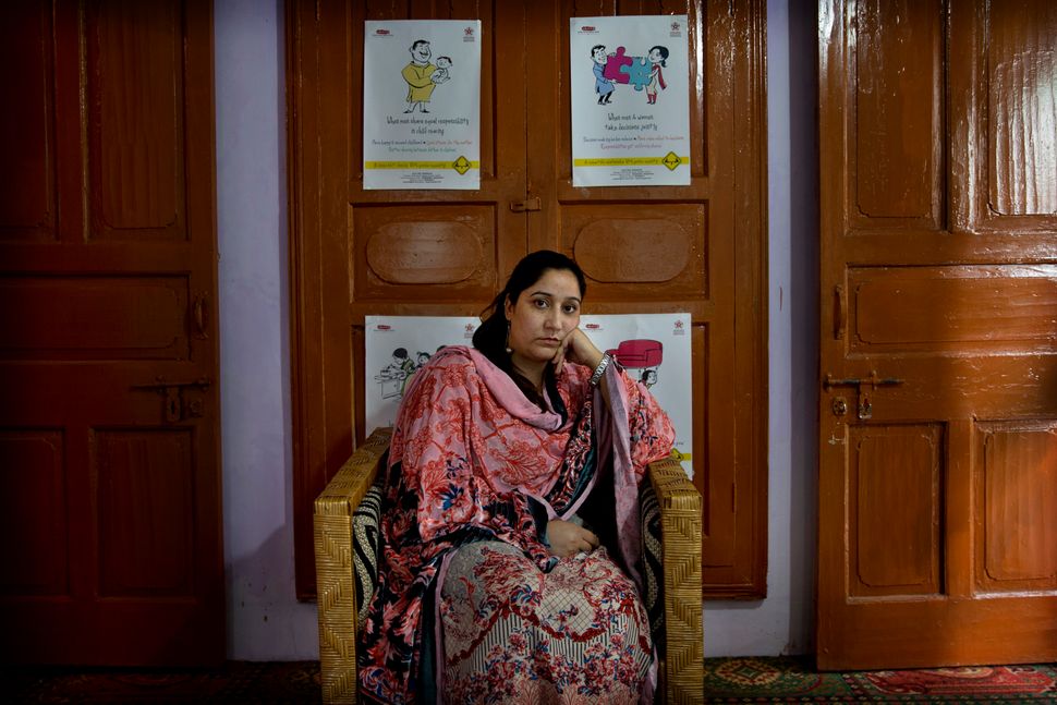 In this Thursday, Oct. 24, 2019, photo, Mantasha Binti Rashid, founder of Kashmir Women's Collective, sits for a photograph in Srinagar. Since the lockdown, her organization has seen a marked rise in violence against women as victims do not have a way to reach out for help. She cites examples: a woman attacked and brought to a hospital 90% covered with burns, many beaten by husbands or thrown out of their homes, another who faced abandonment. “Women suffer disproportionately,” she said. 