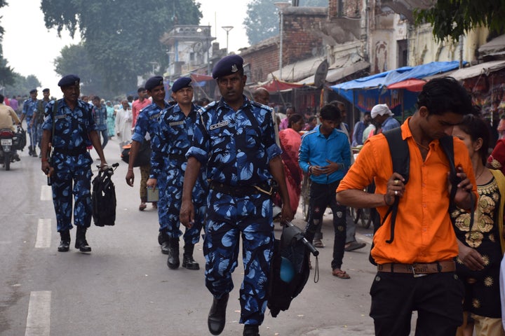 Rapid Action Force (RPF) and Uttar Pradesh Police personnel patrol a street in Ayodhya on November 06, 2019.