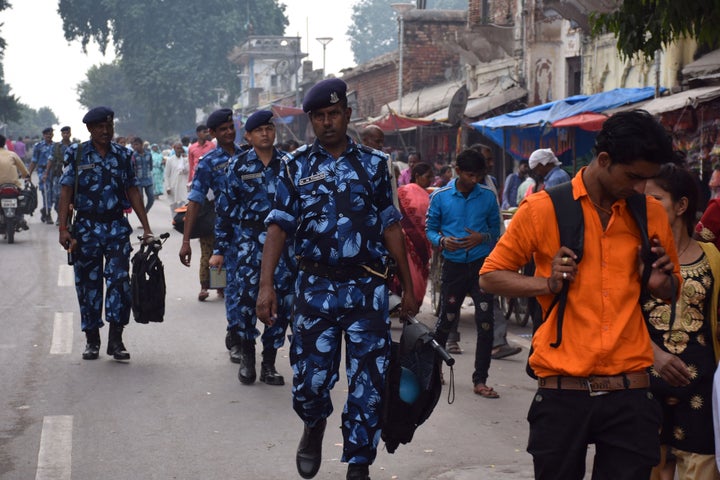 Rapid Action Force (RPF) and Uttar Pradesh Police personnel patrol a street in Ayodhya on November 06, 2019. 