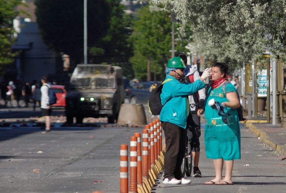 A demonstrator affected by tear gas is helped by others during a protest against Chile's government in Concepcion, Chile November 6, 2019. REUTERS/Jose Luis Saavedra