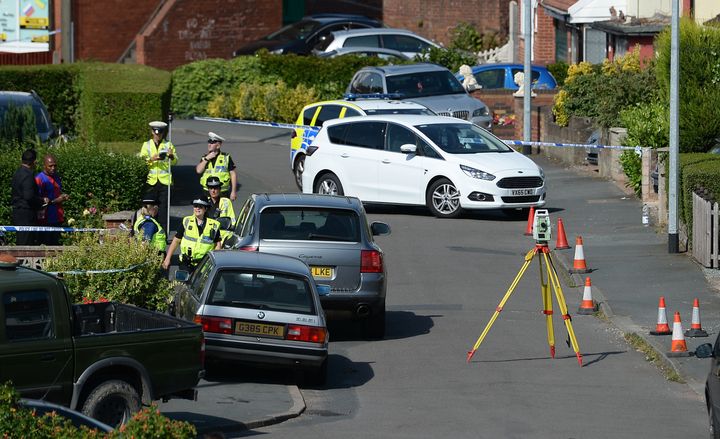 Police survey the scene in Meadow Close in the Trench area of Telford, where the former Aston Villa footballer died after he was Tasered by police 