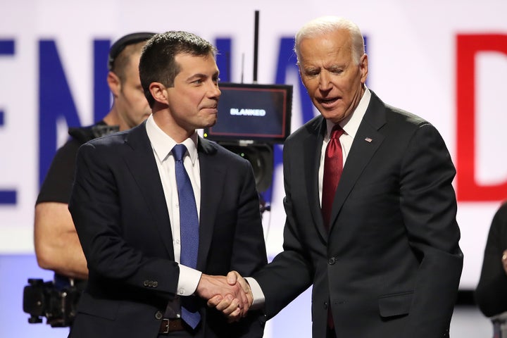 Buttigieg greets Joe Biden before a presidential primary debate on Oct. 15. Biden has run heavily on his ties to Obama, but B