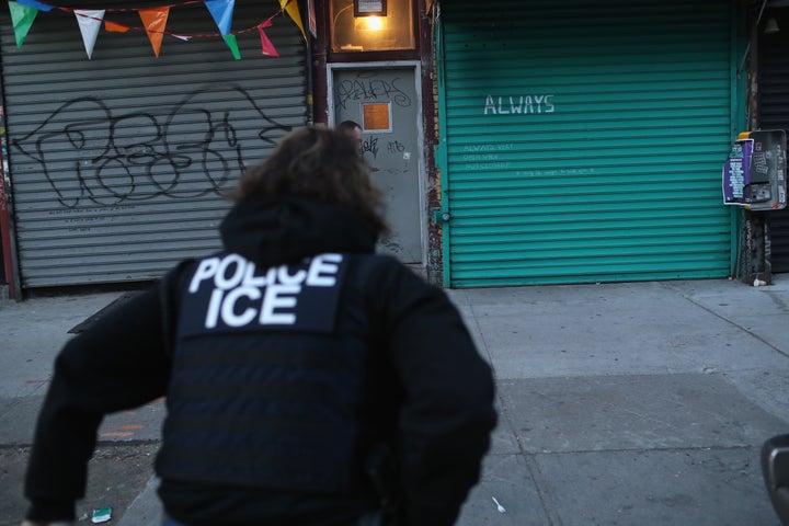 U.S. Immigration and Customs Enforcement officers look to arrest an undocumented immigrant during an operation in the Bushwick neighborhood of Brooklyn on April 11, 2018 in New York City.