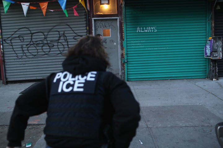 U.S. Immigration and Customs Enforcement officers look to arrest an undocumented immigrant during an operation in the Bushwick neighborhood of Brooklyn on April 11, 2018 in New York City. 