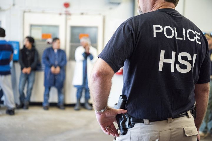 ICE officers in the homeland security investigations (HSI) unit look on after executing search warrants and making arrests at an agricultural processing facility in Canton, Mississippi, on Aug. 7, 2019.
