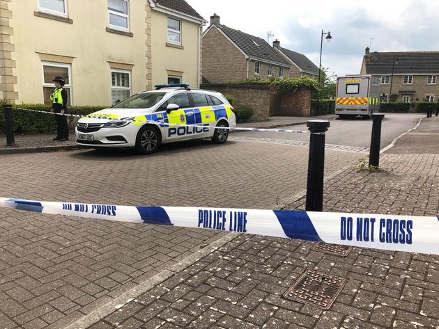 Police at Gould's family home after the discovery of her body 