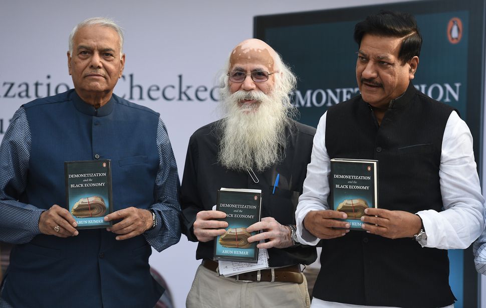Economist Arun Kumar (centre) with former Minister of Finance Yashwant Sinha (left) and former Chief Minister of Maharashtra Prithviraj Chavan during the launch of his book 'Demonetization and The Black Economy' in New Delhi, India.