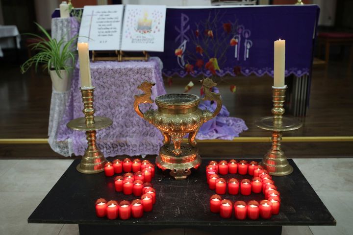 Candles are arranged in a '39' during a Mass and vigil for the victims at The Holy Name and Our Lady of the Sacred Heart Church, east London's Vietnamese church 