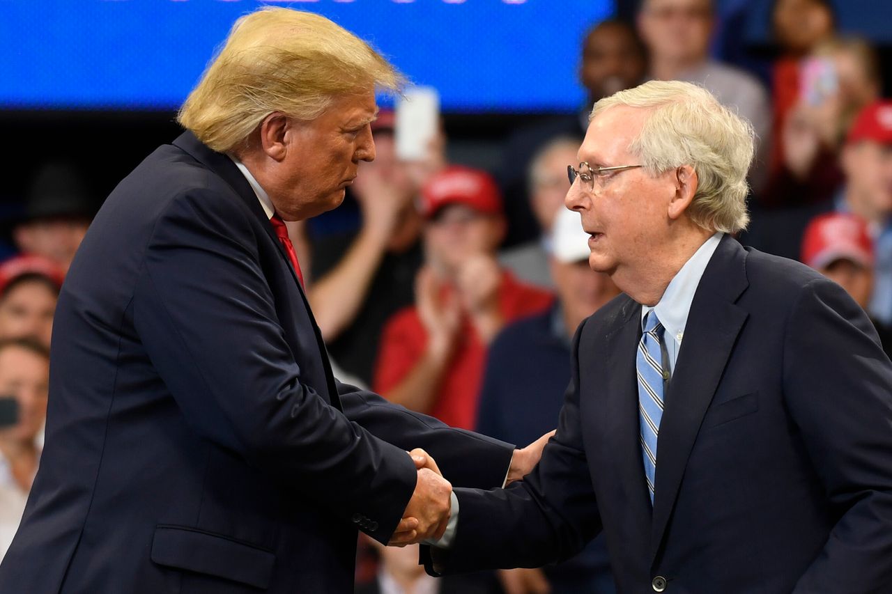 President Donald Trump, left, shakes hands with Senate Majority Leader Mitch McConnell of Ky., as he is brought onstage during a campaign rally in Lexington, Kentucky, Nov. 4, 2019.