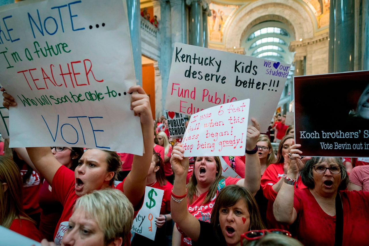 In this Friday, April 13, 2018 photo, teachers from across Kentucky gather inside the state capitol in Frankfort during a rally for increased education funding. Americans overwhelmingly believe teachers don't make enough money, and half say they'd support paying higher taxes to give educators a raise.