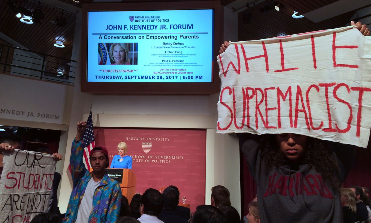 Protesters demonstrate during a speech by Education Secretary Betsy DeVos at Harvard University's Kennedy School of Government on Sept. 28, 2017. Asked about protections for transgender students, DeVos said she was committed to making sure all students are safe. But she rescinded guidance that allowed transgender students to use bathrooms that matched their gender identity.