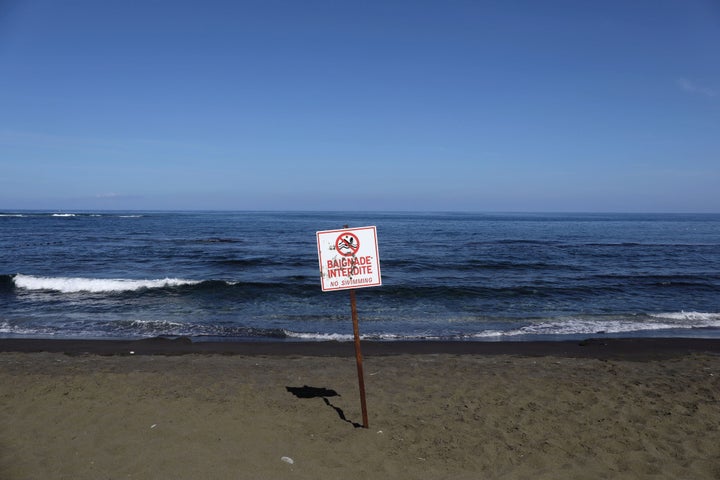 A picture taken on March 1, 2019, shows a sign banning swimming at the L'&Eacute;tang-Sal&eacute; beach, on the Indian Ocean 