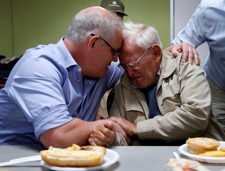 Australia's Prime Minister Scott Morrison comforts 85-year-old evacuee Owen Whalan during a visit to Club Taree Evacuation Centre in Taree.