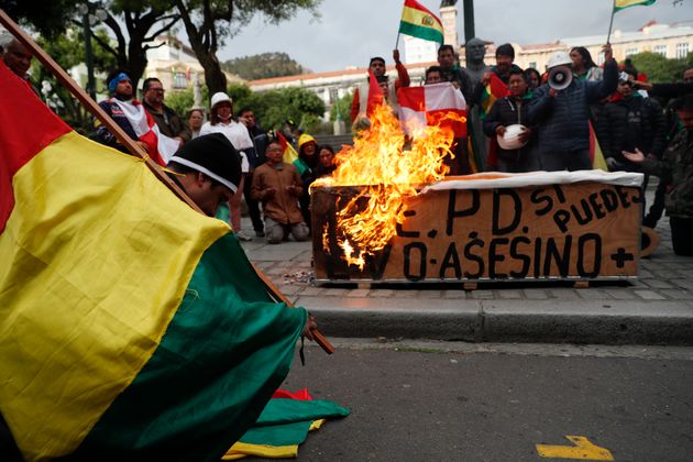 Opponents of Bolivia's President Evo Morales celebrate after he announced his resignation.