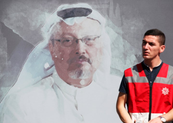 A Turkish police officer walks past a picture of slain Saudi journalist Jamal Khashoggi, near the Saudi Arabia consulate in I