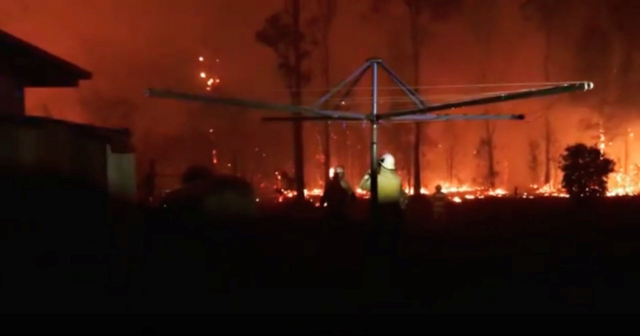 <strong>Firefighters look as a fire rages on in Rainbow Flat, New South Wales.</strong>