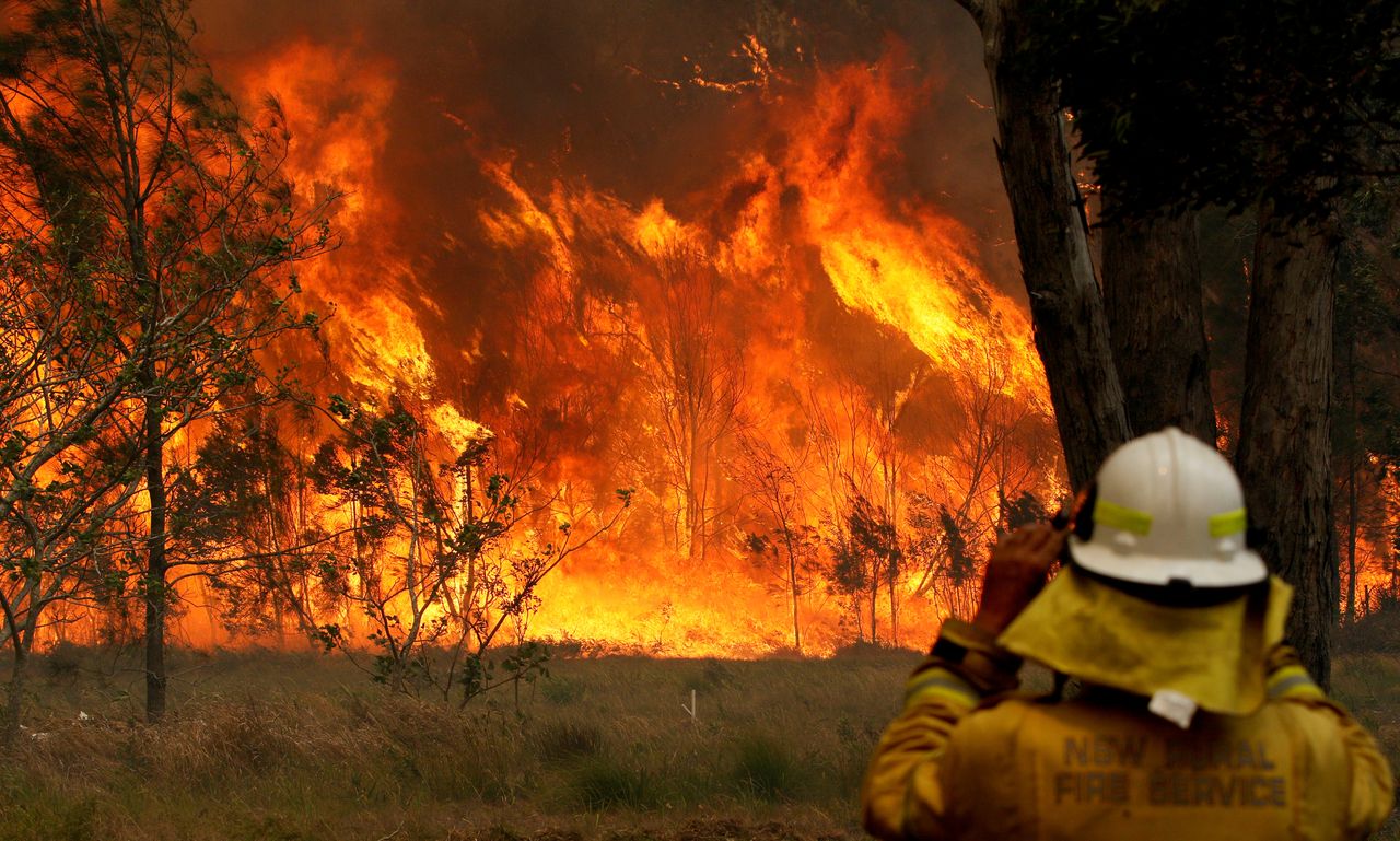 A firefighter on property protection watches the progress of bushfires in Old Bar, New South Wales, Australia November 9, 2019. AAP Image/Shane Chalker/via REUTERS ATTENTION EDITORS - THIS IMAGE WAS PROVIDED BY A THIRD PARTY. NO RESALES. NO ARCHIVE. AUSTRALIA OUT. NEW ZEALAND OUT.