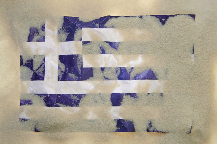greek flag covered with sand