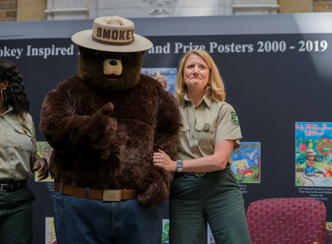 An officer of the Forest Service celebrates Smokey Bear's 75th birthday during a ceremony in Washington, D.C., in August.