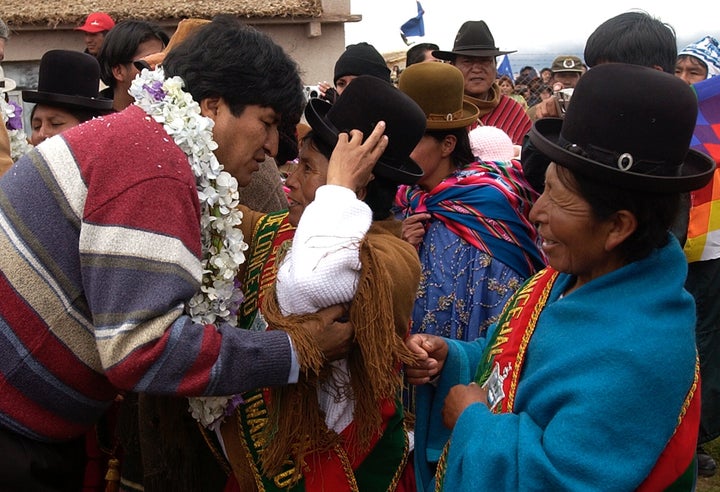 Evo Morales, left, greets supporters at the archaeological site of Tiawanacu, Bolivia, on the eve of his inauguration as Bolivia's new president on Jan 21, 2006.