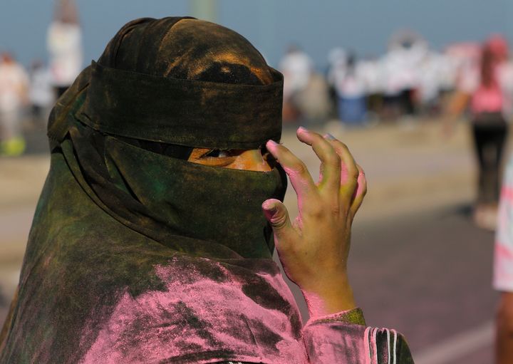 A woman wearing a Niqab participates in the colored powder event the Color Run, in Jeddah, Saudi Arabia, Nov. 2, 2019.