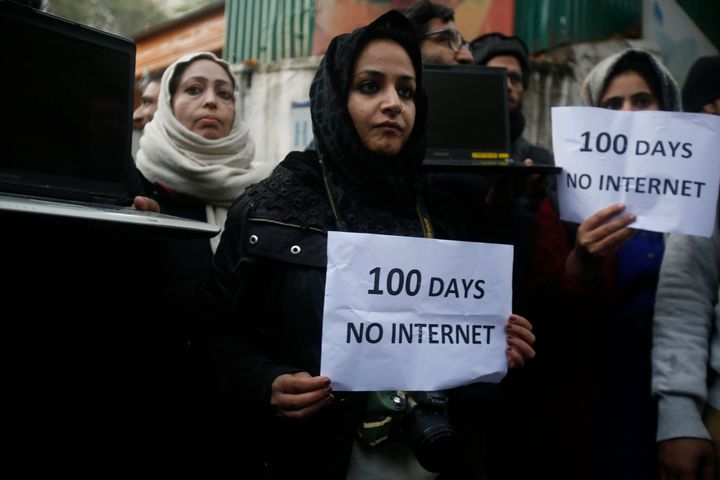 Kashmiri journalists hold placards and protest against 100 days of internet blockade in Srinagar, part of Indian-controlled Kashmir, on Tuesday