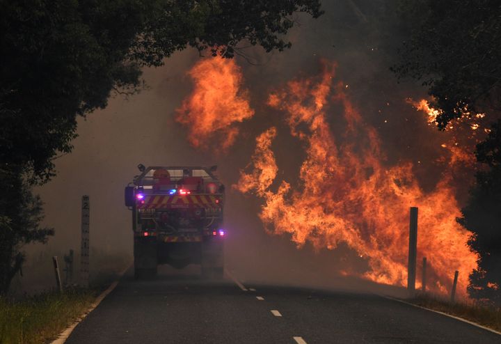 A fire truck is seen near a bushfire in Nana Glen. 