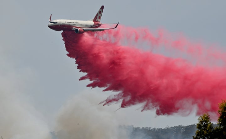 Rural NSW Fire Service plane drops fire retardent on an out of control bushfire near Taree, 350km north of Sydney. 