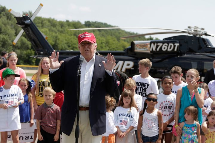 Presidential candidate Donald Trump talks to the media in Des Moines after arriving by helicopter and before attending the Iowa State Fair on Aug. 15, 2015.