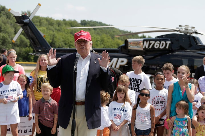 Presidential candidate Donald Trump talks to the media in Des Moines after arriving by helicopter and before attending the Io