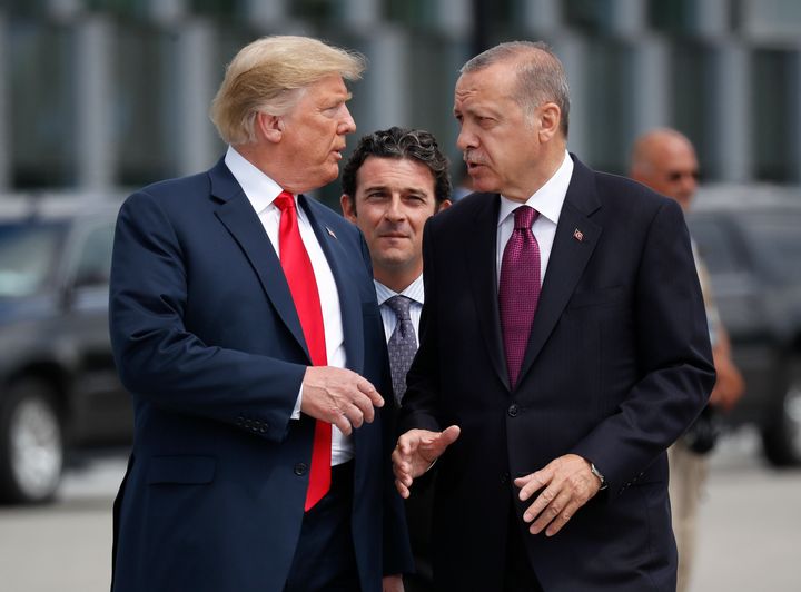 In this Wednesday, July 11, 2018, file photo, President Donald Trump, left, talks with Turkey's President Recep Tayyip Erdogan, as they arrive together for a family photo at a summit of heads of state and government at NATO headquarters in Brussels. 