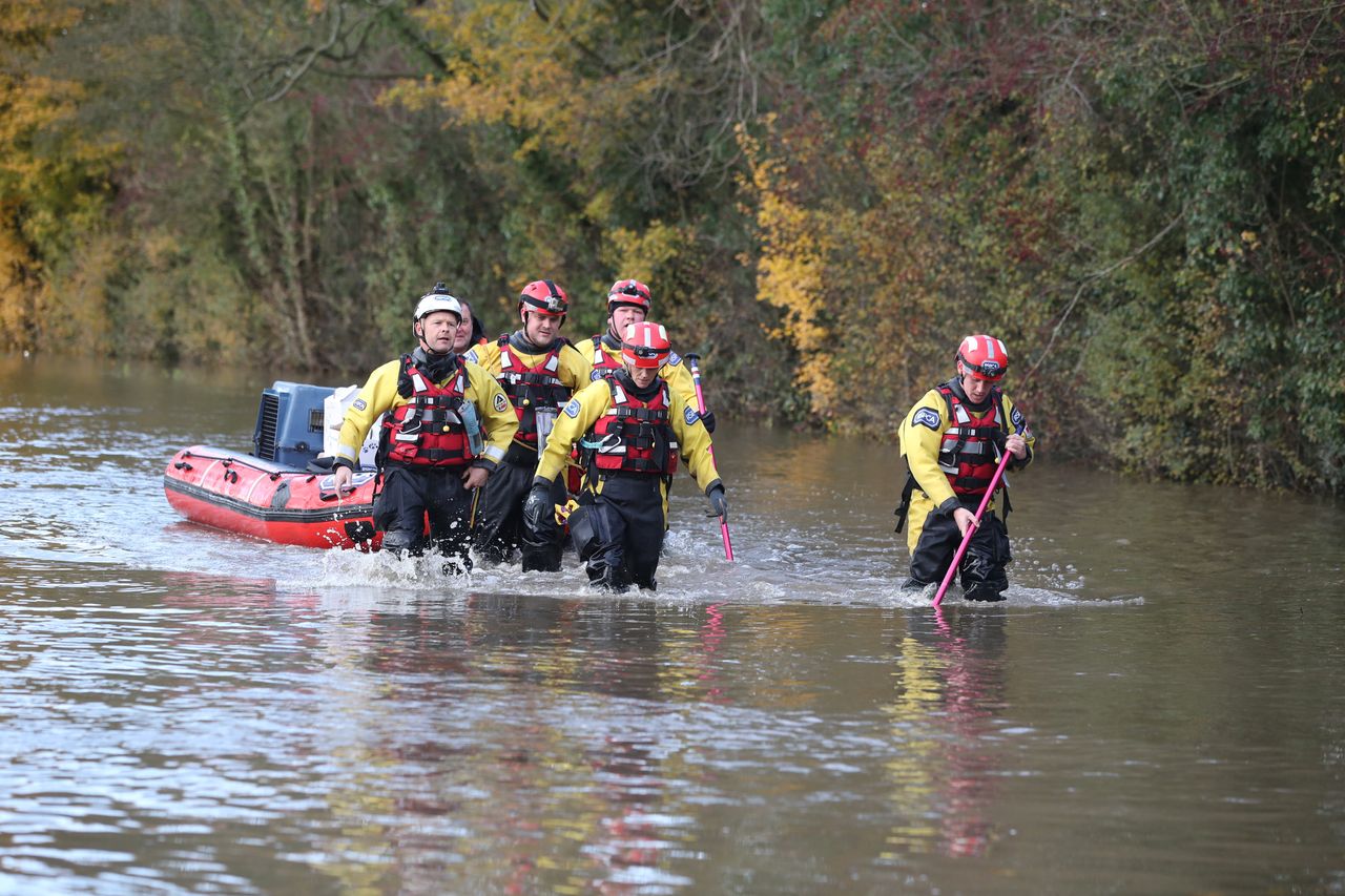 Rescuers pull a boat through floodwater in Fishlake, Doncaster