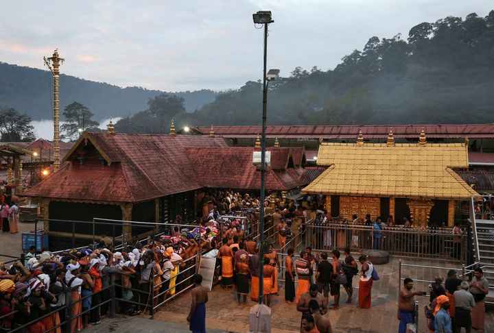 Devotees wait in queues inside the premises of the Sabarimala temple in Pathanamthitta district in Kerala, 18, 2018. 